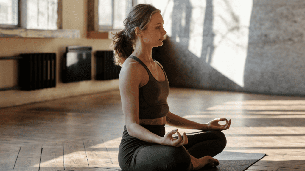 Yoga teacher conducting virtual yoga class at home on a video